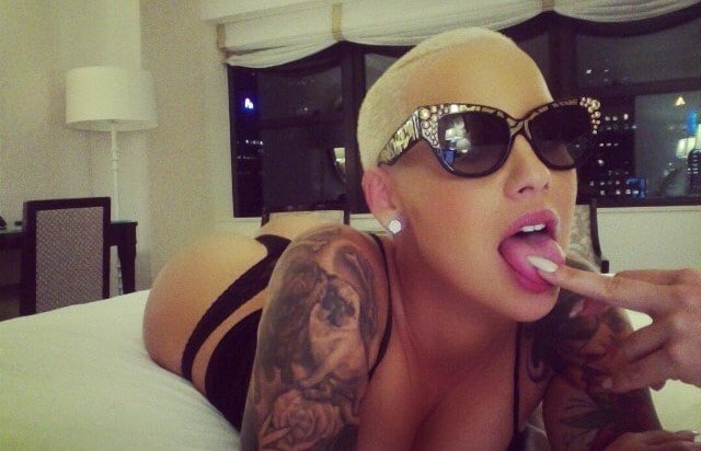 amber rose sex tape pic laying in bed with tongue out