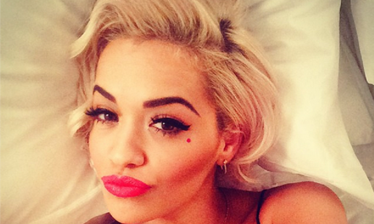 Rita Ora with her head on a pillow