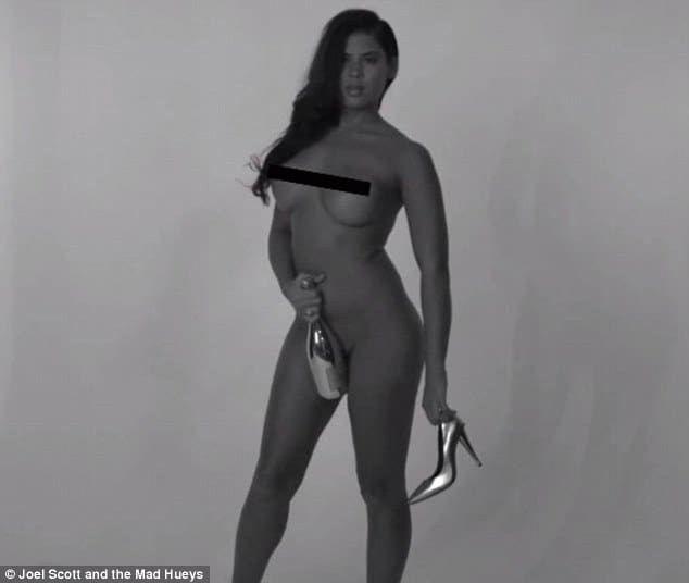 Swimwear designer noni janur takes naked pick with champagne bottle covering her ass