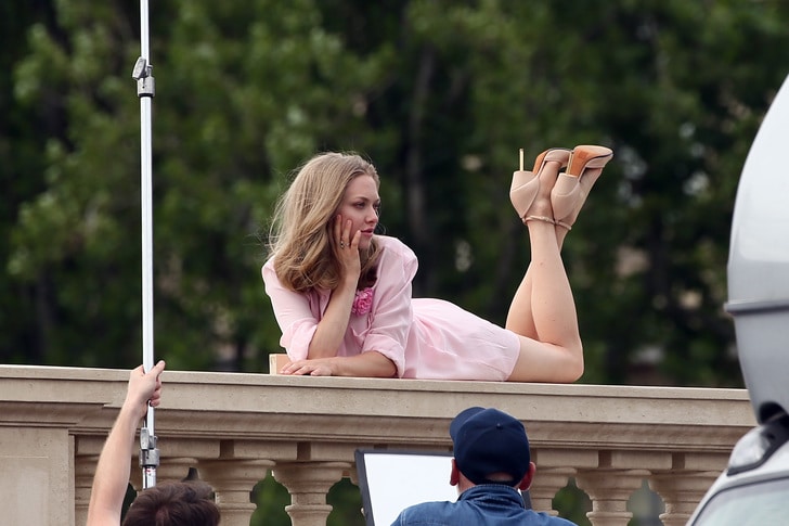 paris modeling shoot of amanda seyfriend laying on balcony with hand on her face