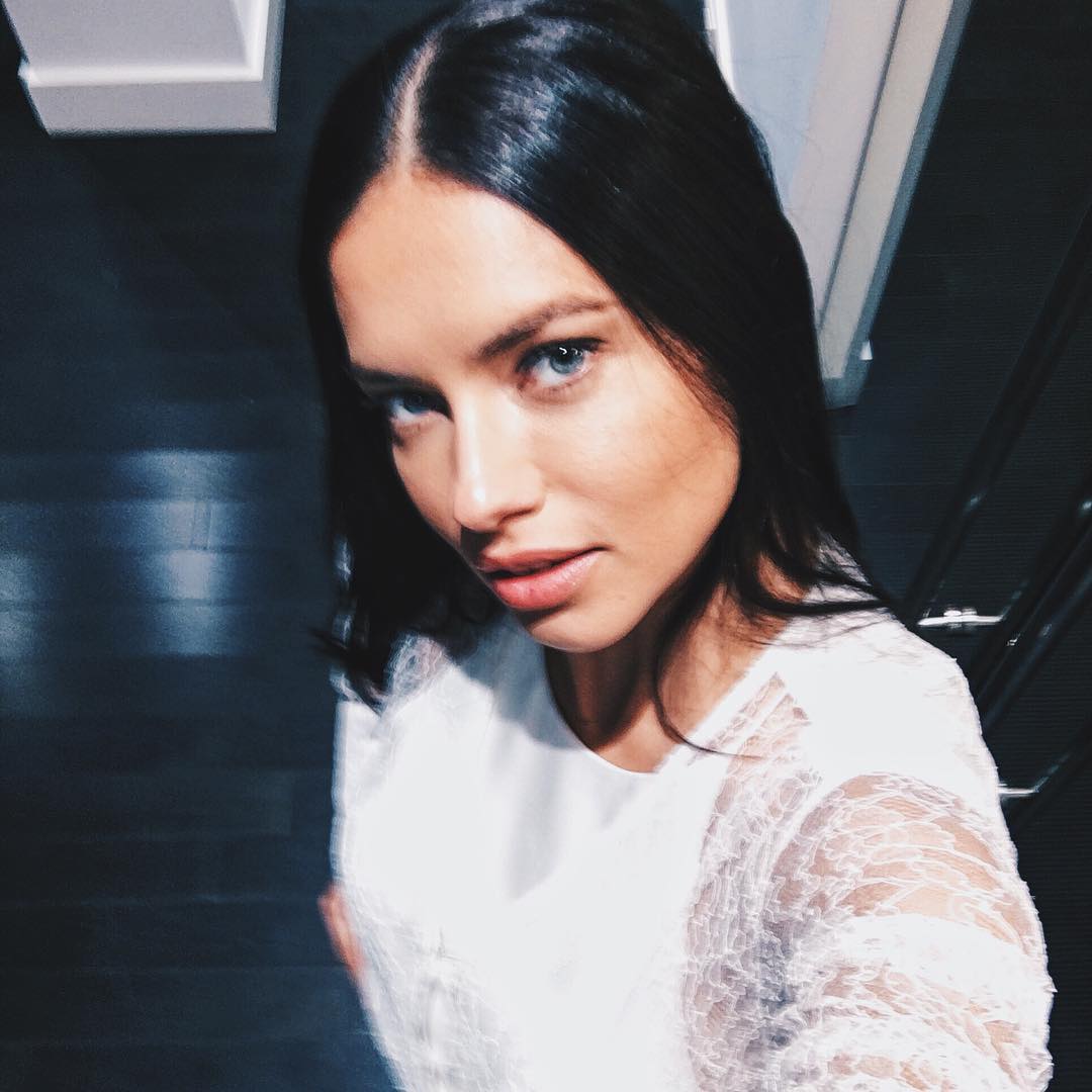Adriana Lima taking a selfie in a white top from above