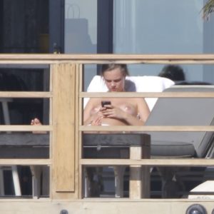 Cara Delevingne topless sunbathing